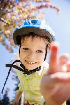 Young boy in helmet looking at camera and going to touch it Stock Photos