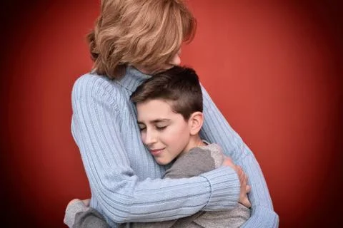 Young boy hugging his mother Stock Photos
