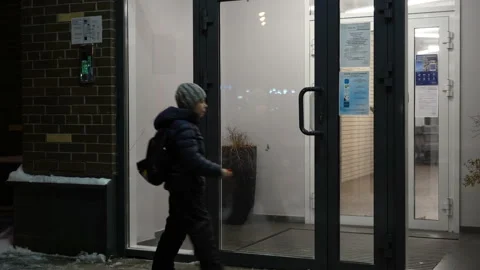 Young boy input open code on intercome and enter apartment building at winter Stock Footage 168893151