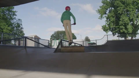 Young Boy Jumping Off Ramps with His Sco... | Stock Video | Pond5