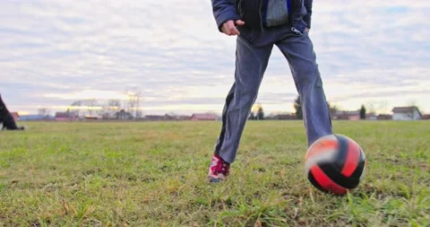 A young boy kicks the ball LOW SHOT Stock Footage 145919997