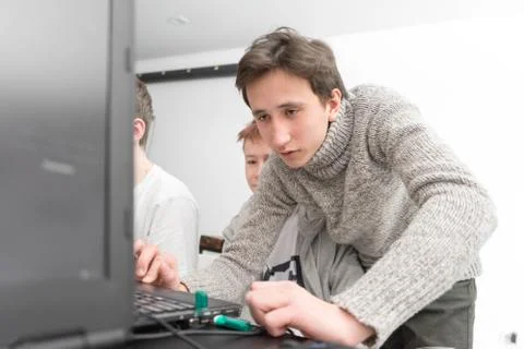 A young boy with a laptop working Stock Photos