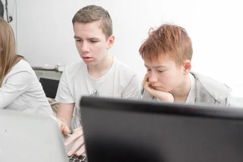 A young boy with a laptop working Stock Photos