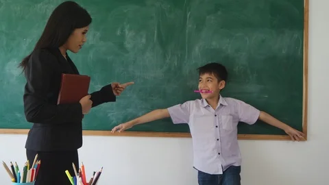 Young boy laughing while his teacher punish him Stock Footage 90275765