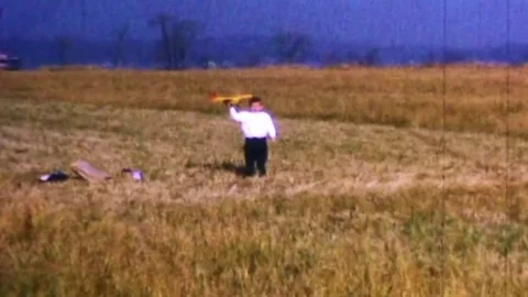 Young boy launches his model airplane for first time Stock Footage 83333241