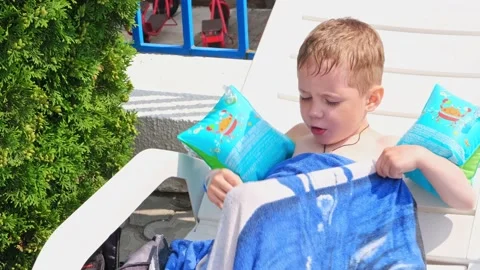 Young boy laying in the sun. Cute child having a rest, outdoors Stock Footage 161216012