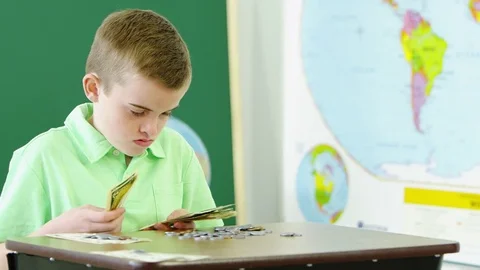 Young boy learning and counting money Video stock 80131355