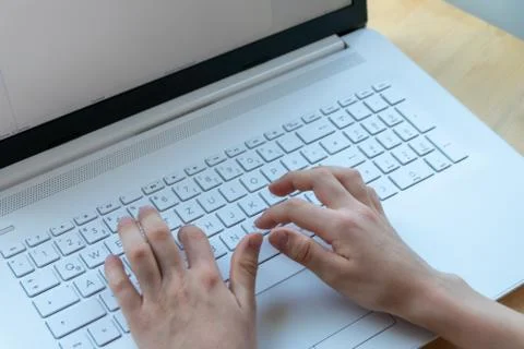 Young boy is learning to code and program at a white notebook Foto stock