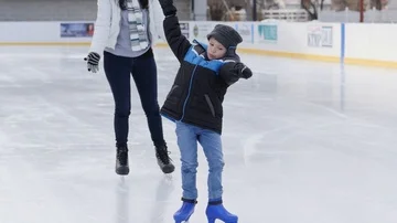 Young boy learning to ice skate moves toward camera then falls Stock Footage 85651792