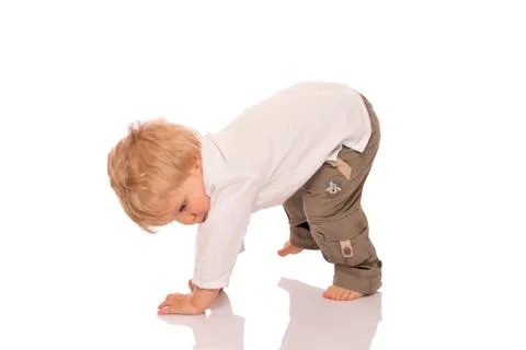 Young boy learning to walk Stock Photos