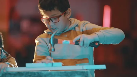 Young boy learning woodworking skills in workshop Stock Footage 329544955