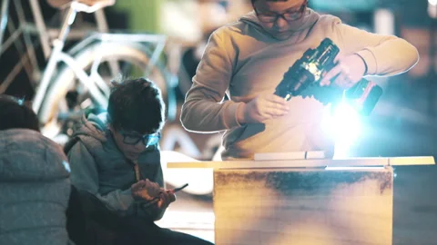 Young boy learning woodworking using power drill Stock Footage 329558828