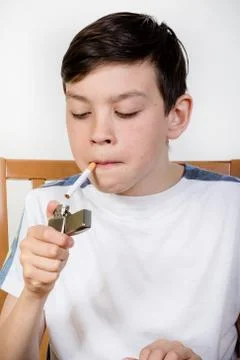Young boy lighting a cigarette Stock Photos