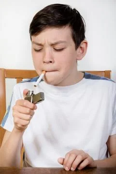 Young boy lighting a cigarette Foto stock