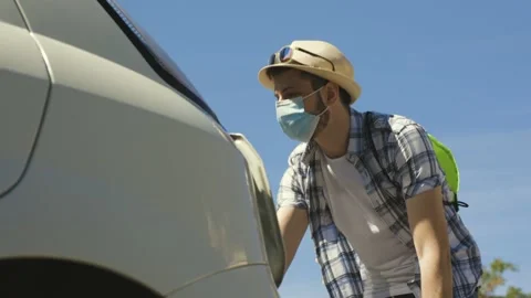 A young boy is loading his suitcase in the car and travelling with some friends Stock Footage 155249074