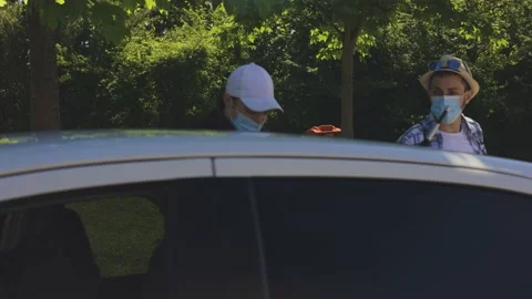 A young boy is loading his suitcase in the car and travelling with some friends, Stock Footage 155249261