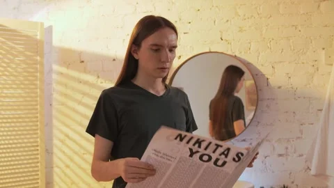Young boy in a loft apartment walks up to a sink with a mirror Stock Footage 245616864