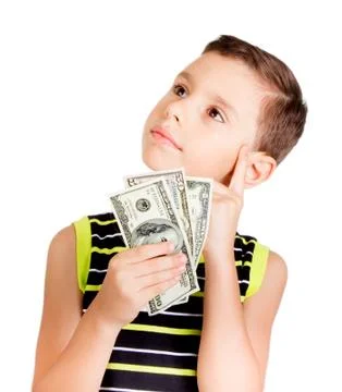 Young boy looking up and thinking what to buy with money Foto stock