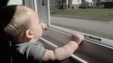 Young boy looking at car drive by in neighborhood 4k Stock Footage 332957508