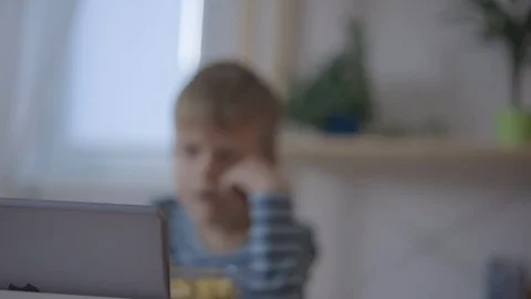 Young boy looking on a digital tablet with popcorn Stock Footage 102018262