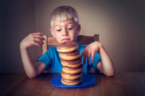 Young Boy Looking At Donuts Stock Photos