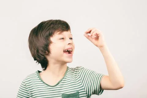 Young boy looking at his first lost milk tooth Stock Photos