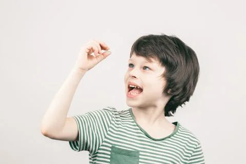 Young boy looking at his first lost milk tooth Stock Photos