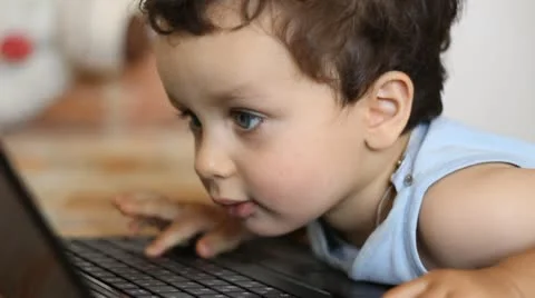 Young boy looking at a lap top screen Stock Footage 11098395