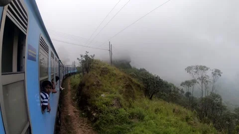 Young boy looking at the misty view - Kandy to Ella train. HD Stock Footage 141578437