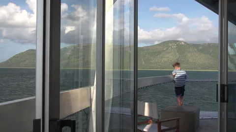 Young Boy Looking at Mountains From Cruise Ship Deck Balcony Stock Footage 338405565
