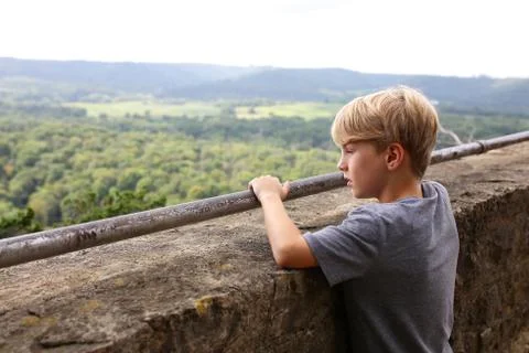 Young Boy Looking Out over Ledge of Tourist Scenic Cliff Viewing Deck Stock Photos