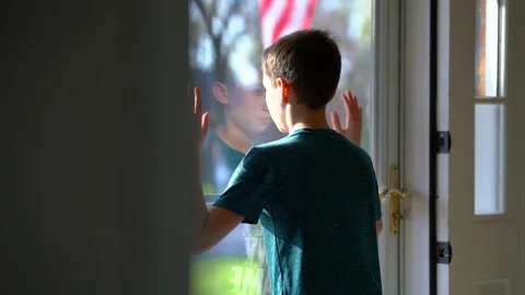 Young Boy Looking Outside Through Glass Door 스톡 동영상 149897260