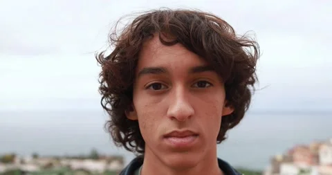 Young boy looking serious on camera Stock Footage 164378974