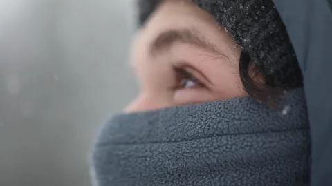 Young boy looking in the sky while snowing 스톡 동영상 174741525