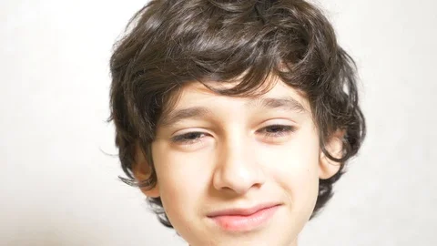 A young boy looks at the camera and smiling. 4k. Slow motion Stock-Footage 87498367