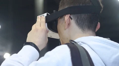 Young Boy looks at the virtual reality helmet Stock Footage 87136142