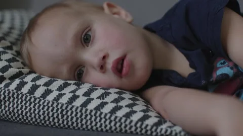 Young boy lying awake in bed seeking sleep serene and carefree nature of Stock Footage 280032841