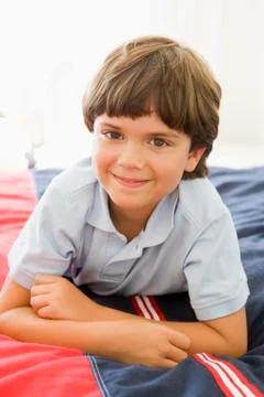 Young Boy Lying Down On His Bed Stock Photos