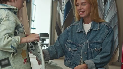 Young boy made his own pair of jeans during clothes-making workshop and showed Stock Footage 313232823
