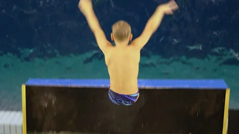 Young boy makes flip during water jump in RGUFK basin. Slow motion Stock Footage 276367796