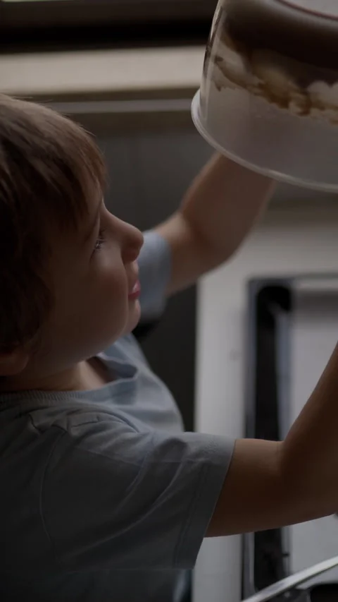 Young boy making chocolate cookies Stock Footage 327011279