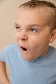Young boy making a funny face while playing around Stock Photos