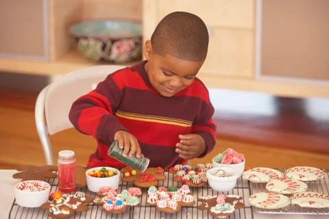 Young boy making gingerbread men Stock Photos