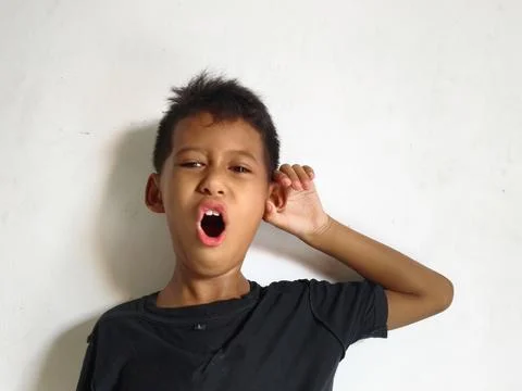 Young boy making a stop or rejection gesture with crossed arms 库存照片