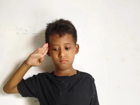 Young boy making a stop or rejection gesture with crossed arms 库存照片