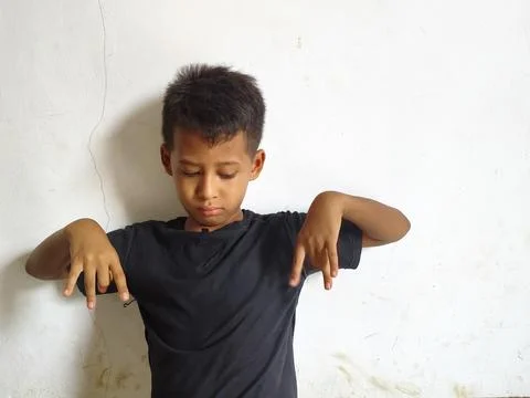 Young boy making a stop or rejection gesture with crossed arms Фото