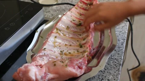 Young boy marinating pork rib Stock Footage 246833531