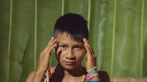 Young boy massaging the temples with eyes closed suggesting headache in ecuador Stock Footage 113180823