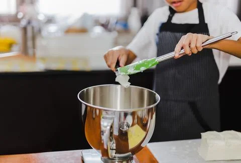 Young boy measuring ingredient for baking in kitchen. Stock Illustration
