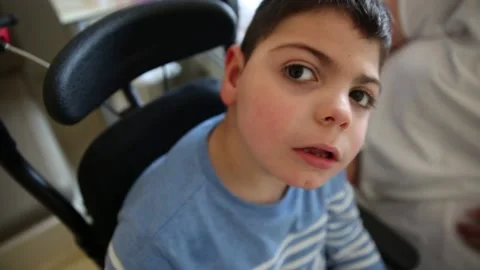 Young boy with multiple disabilities irritated and exhausted while in a visit at Video stock 191081216